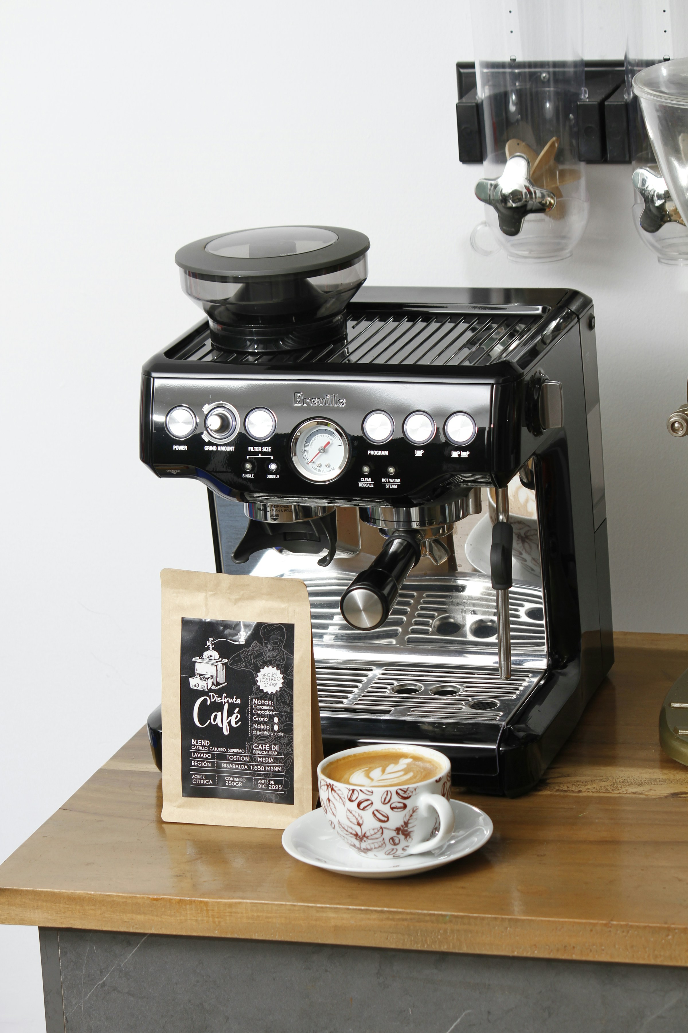 Black Breville Barista Express with manual controls, a steam wand and a portafilter