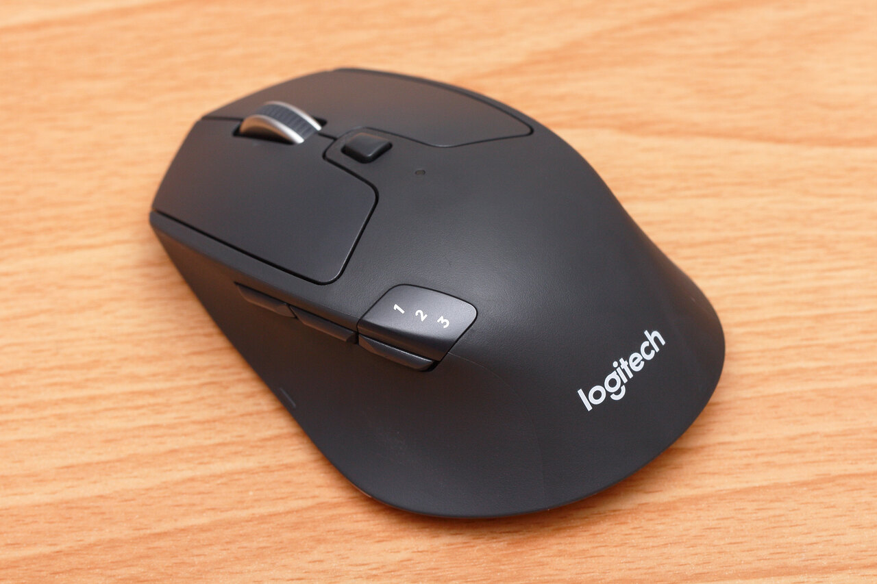 Logitech M720 Triathlon mouse photographed on a wooden surface